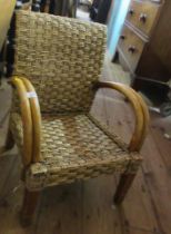 A child's chair, with woven decoration and bent scroll arms