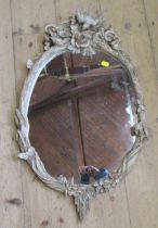 A wall mirror, the carved oval frame decorated with birds, insects and animals, overall height