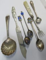 A collection of flatware, to include a silver sifting spoon, a silver spoon with enamel