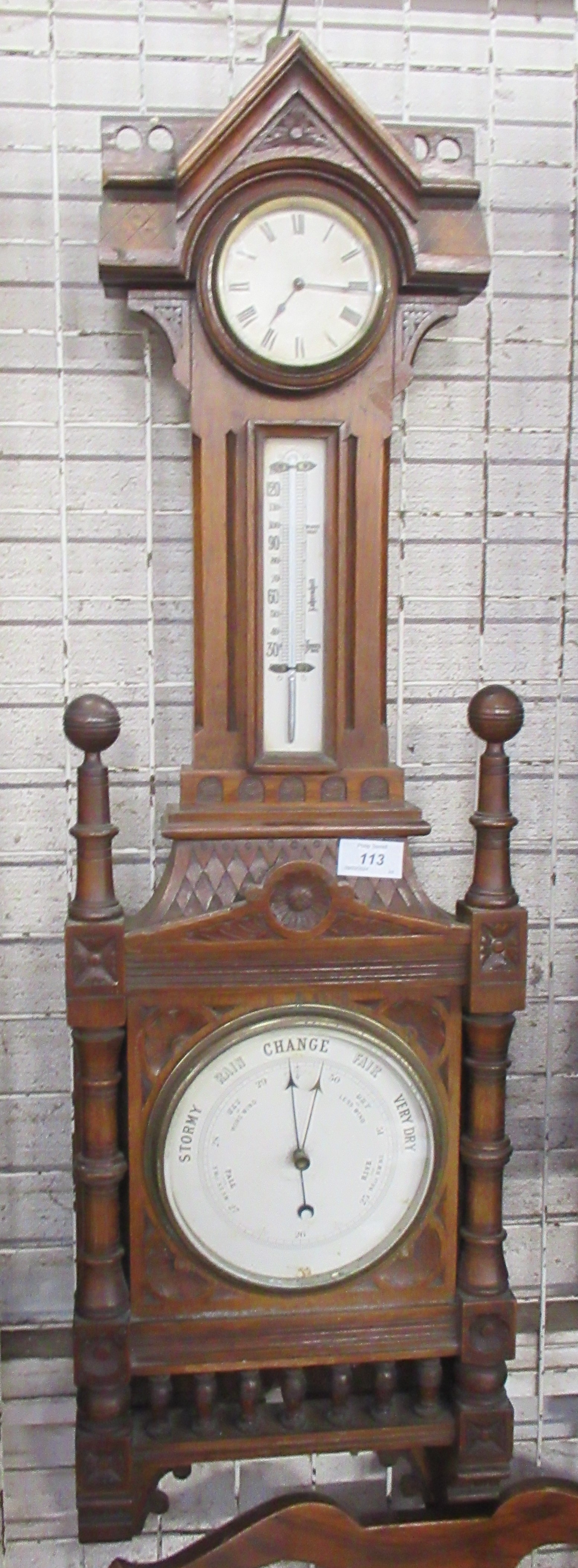 A 19th century oak cased barometer, with thermometer and clock, height 34ins