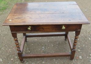 An Antique oak table, fitted with a frieze drawer, on turned legs united by stretchers, 23ins x