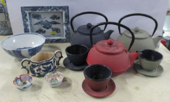 A collection of Eastern items, to include three metal tea pots, beakers and saucers, etc
