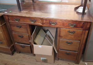 A desk, fitted with eight drawers around the kneehole, 48ins x 23.5ins, height 32.5ins