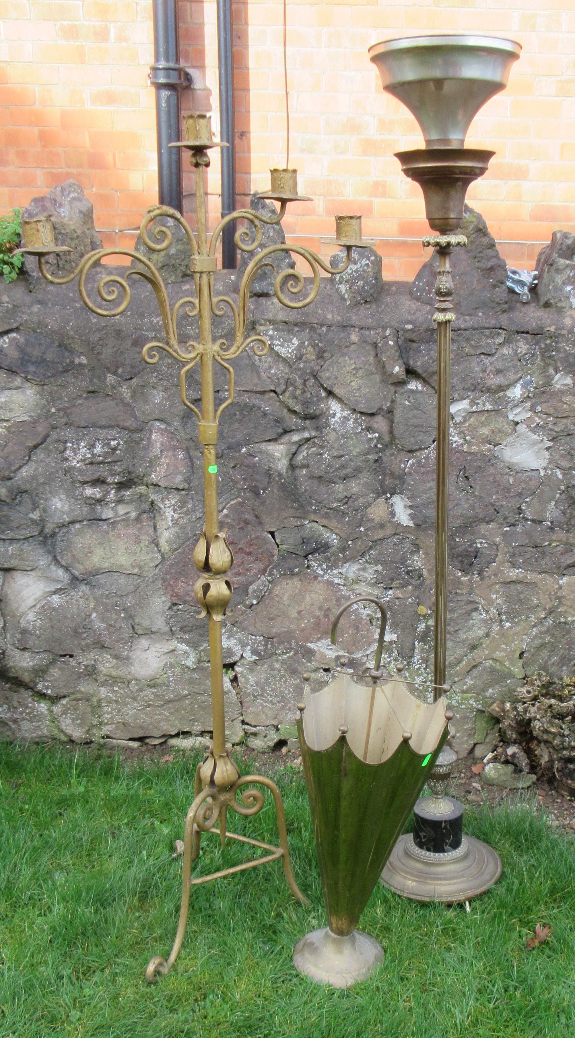 A floor standing candle stand, height 58ins, together with a brass umbrella shaped umbrella stand