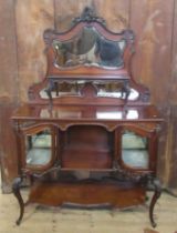 An Edwardian mahogany mirror back cabinet, fitted with a shelf, over glazed cupboards and shelves,