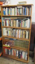 A modern pine bookcase, 66ins x 36ins, depth 10ins, together with a quantity of books