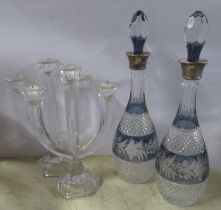 A pair of overlay glass decanters, with silver collars, height 15.5ins, together with a pair of