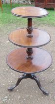 A 19th century mahogany three tier dumb waiter, with circular tiers supported by carved columns,