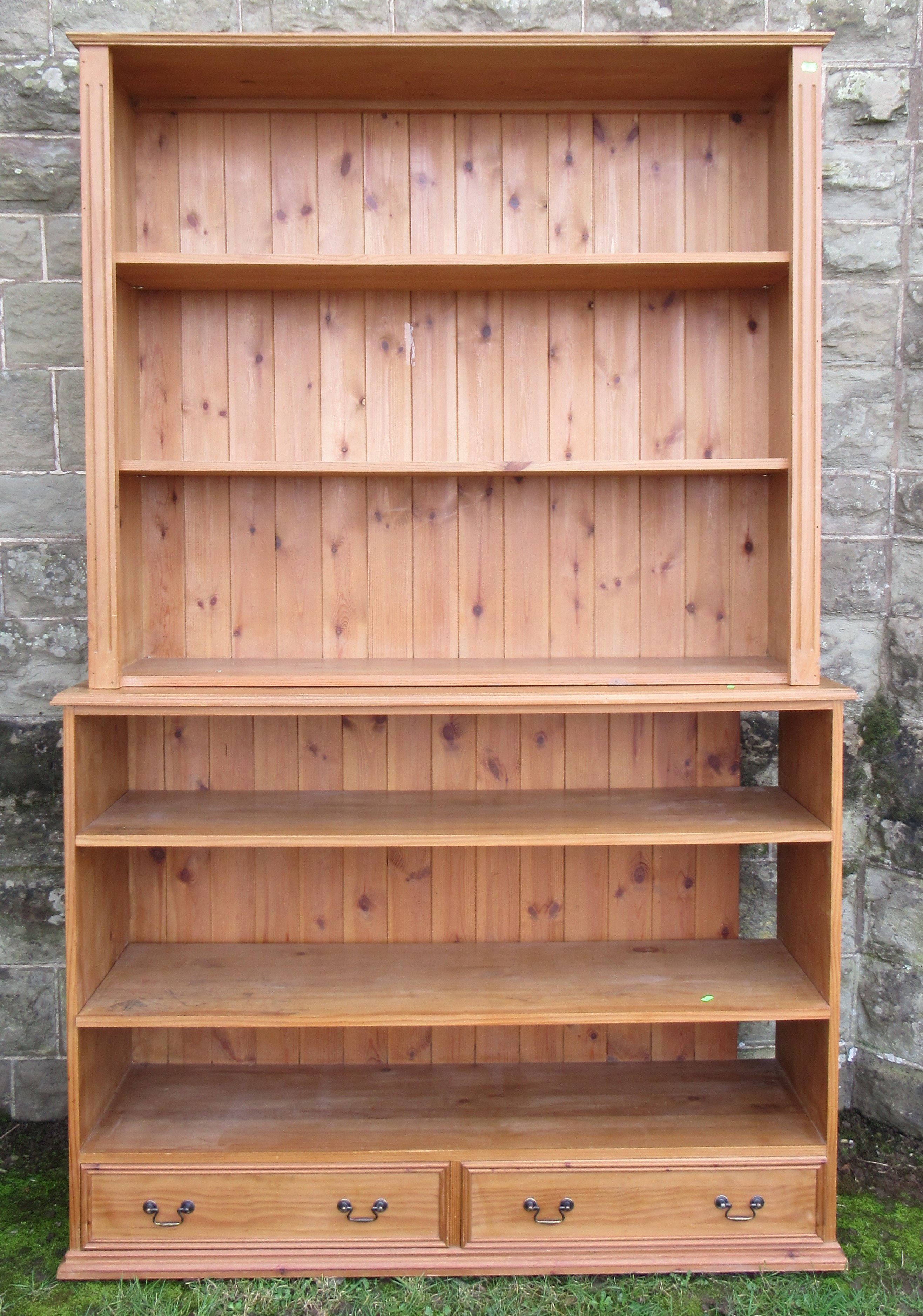 A pine double bookcase, fitted with two drawers to the base, width 54ins, depth 16ins, height 84ins