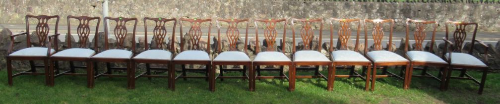 A set of 12 (10+2) mahogany dining chairs, with pierced vase splat backs and drop in seats