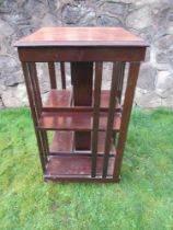 A mahogany revolving book stand 19" square, height 36ins