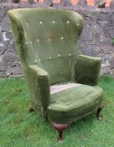 A curved back wing armchair