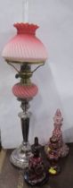 A silver plated and cranberry glass oil lamp, height 24ins, together with three 19th century ruby