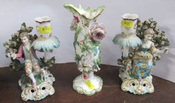 A pair of Continental porcelain candlestick, with figures and flowering tree, gold anchor mark,