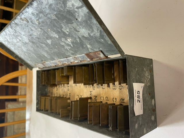 A box of  metal letter stencils