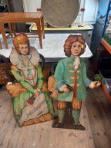 A pair of painted stands , decorated with figures in period dress