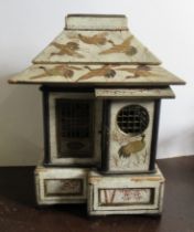 A Japanese lacquer model, of a house, decorated in gilt with storks and bamboo to a white ground,