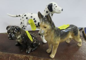 Three Royal Worcester models of dogs, to include a standing Dalmatian, a brindle seated Bulldog