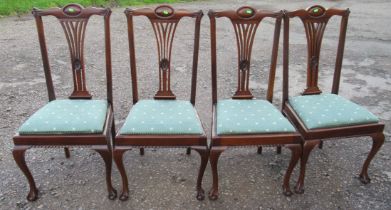 A set of four mahogany dining chairs, with pierced vase splat and drop in seats