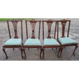 A set of four mahogany dining chairs, with pierced vase splat and drop in seats