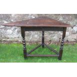 An Antique oak corner table, of triangular form, 43ins x 25ins, height 30ins