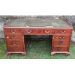 A mahogany pedestal desk, with leather writing surface, fitted with an arrangement of nine drawers