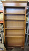 A bookcase, with swag decoration, height 81.5ins, width 40ins, depth 12ins