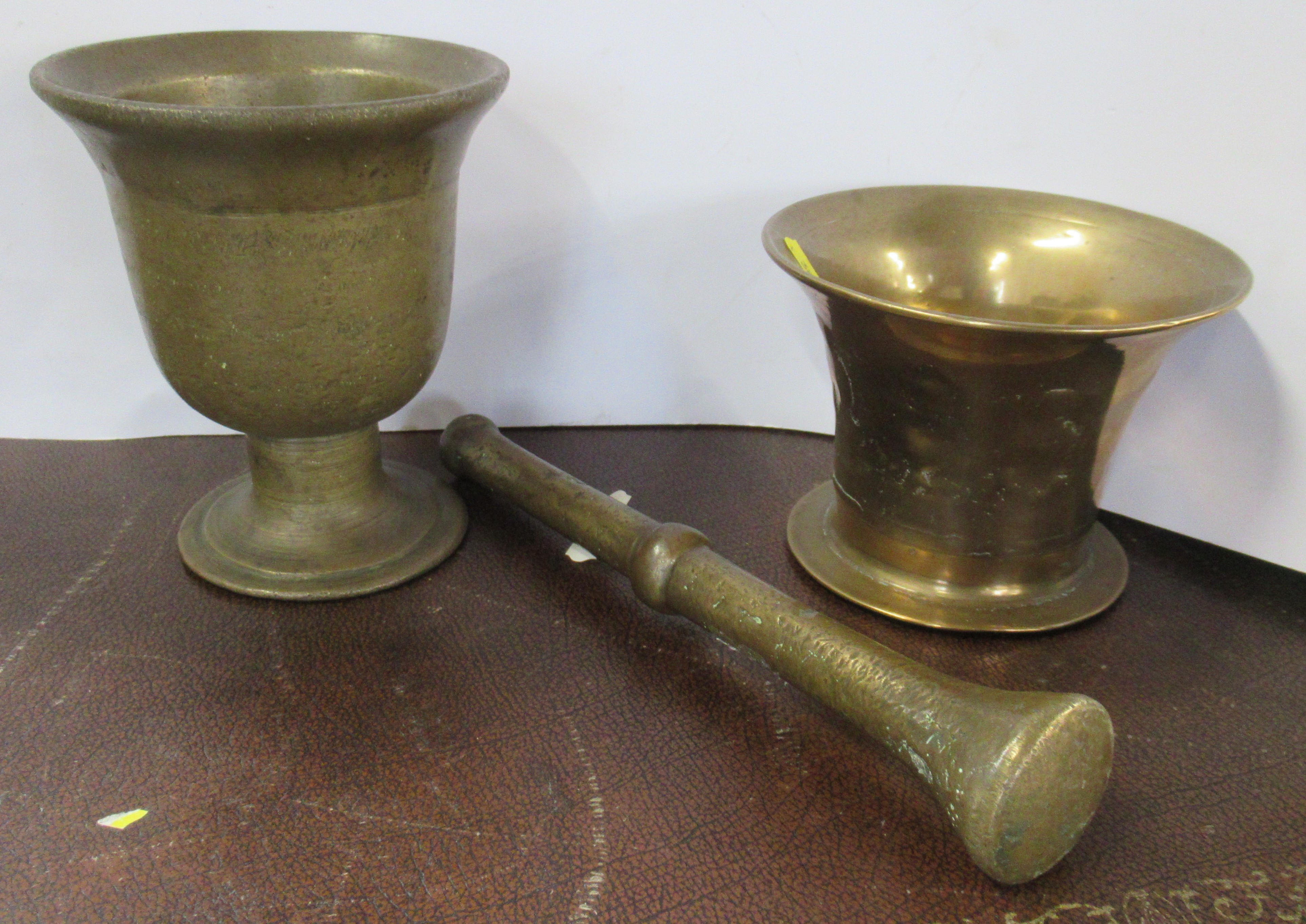 Two brass mortars and a pestle