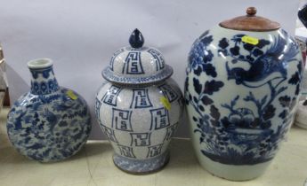 Three Oriental vases, decorated in blue and white, height 12ins and down