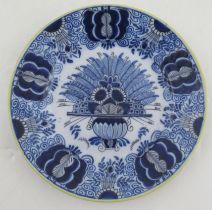 A delft plate, with a central floral panel to a similarly decorated boarder