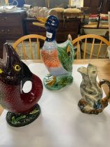 A collection of novelty duck, fish and frog jugs, some af