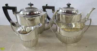 A silver three piece tea set, together with another silver tea pot