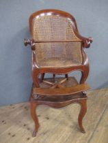 A 19th century mahogany childs caned back chair, raised on a table, with cabriole legs height 40ins