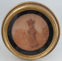A Hadley's Worcester circular terracotta plaque, decorated with a young girl carrying a basket of