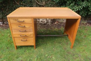 A vintage oak knee hole desk, fitted to one side five graduated drawers, 48ins x 24ins x 29.5ins