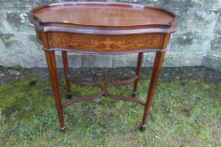 An Edwardian shaped occasional table, with a marquetery front frieze, raised on square tapering legs