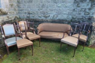 An Edwardian mahogany salon suite, with bone inlay, comprising two seat sofa, two arm chairs, two