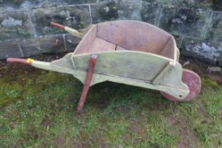 A child's wooden toy wheel barrow