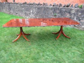 A reproduction mahogany twin pedestal table, with two extra leaves max  length 100ins