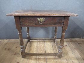 An Antique oak side table, fitted with frieze drawer, raised on turner legs, united by stretcher,