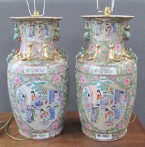 A pair of 20th century Chinese famille rose vases, converted to lamps, decorated with warriors and