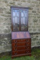 A reproduction mahogany bureau bookcase, with fitted glass doors and four drawers, width 29ins