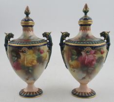 A pair of Royal Worcester Hadley ware covered vases, painted with roses, with griffin mask