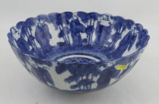 A Chinese blue and white punch bowl, decorated with figures and trees inside and outside, with