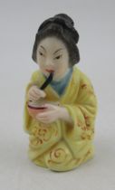 A Royal Worcester candle snuffer, a geisha girl,1893, height 2.75ins  Condition Report: Damage to