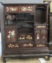 A Japanese shibayama cabinet, fitted with shelves, cupboards and drawers, decorated with flowers,