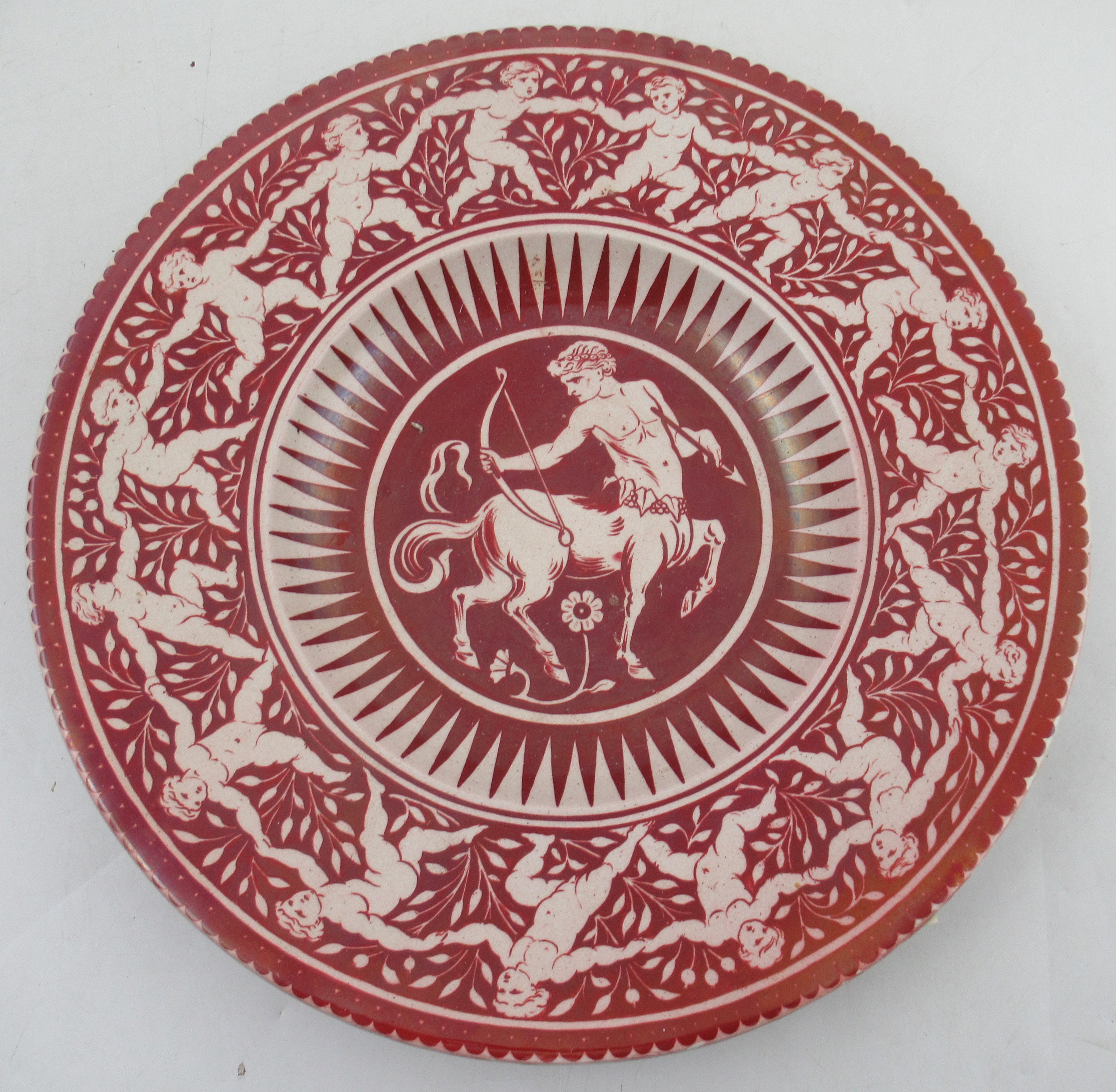 A 19th century William De Morgan ruby lustre circular charger, decorated to the centre with a