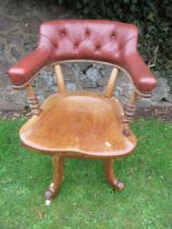 A 19th century saddle seat swivel office chair, with open gallery supporting a leather or