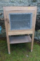 A pine meat safe, with mesh grill raised on a stand, width 28ins