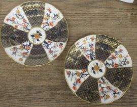 A pair of Royal Worcester saucer dishes, decorated with fans of flowers and blue and gilts in the